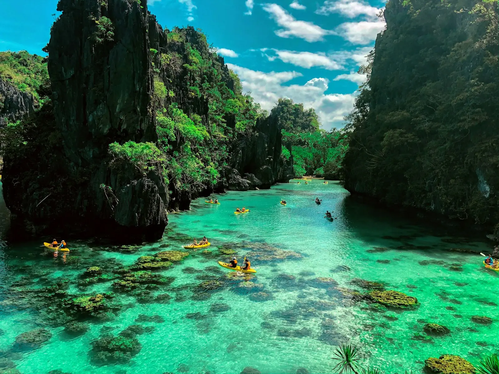 Turquoise lagoon surrounded by limestone cliffs in El Nido, Palawan