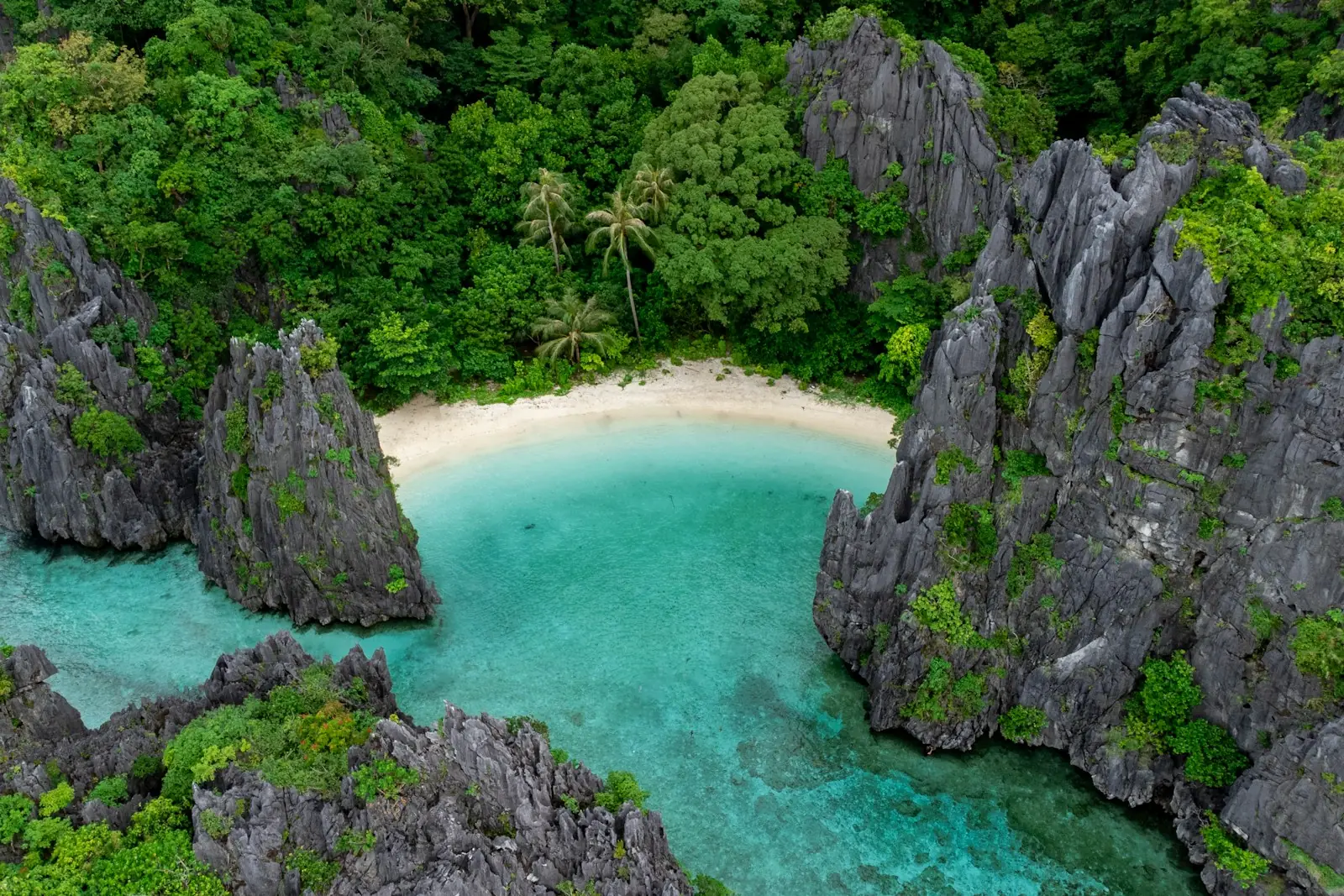 Hidden beach between limestone cliffs in El Nido, Palawan