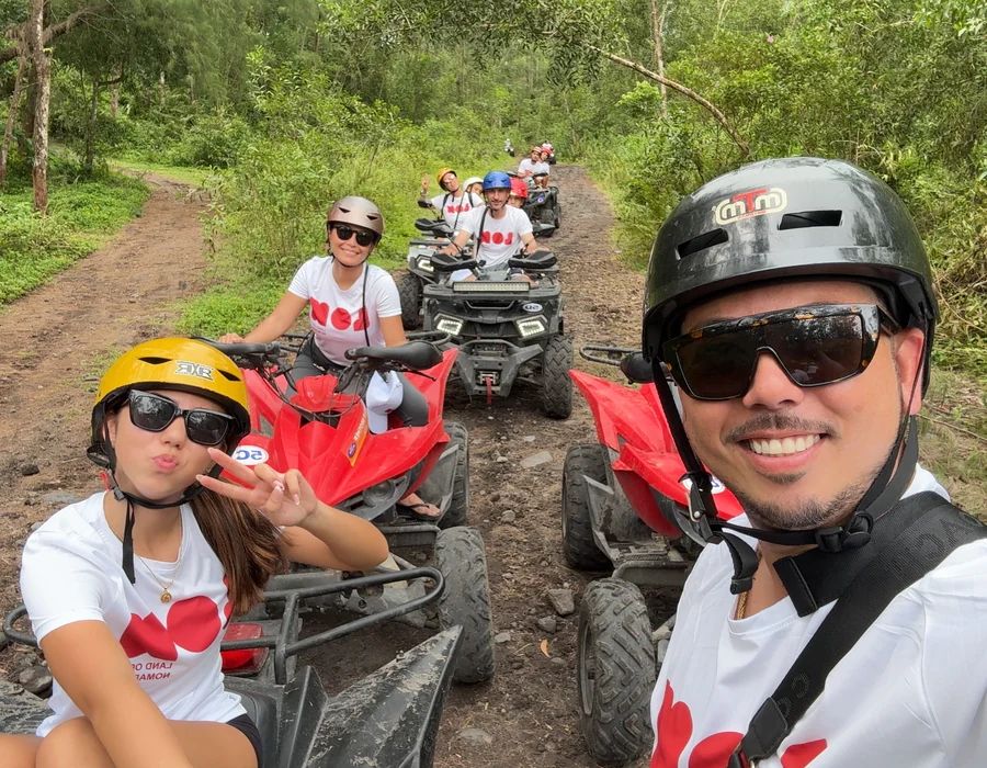 Group riding quads on a jungle trail in Camarines Sur, wearing Land of Nomads shirts