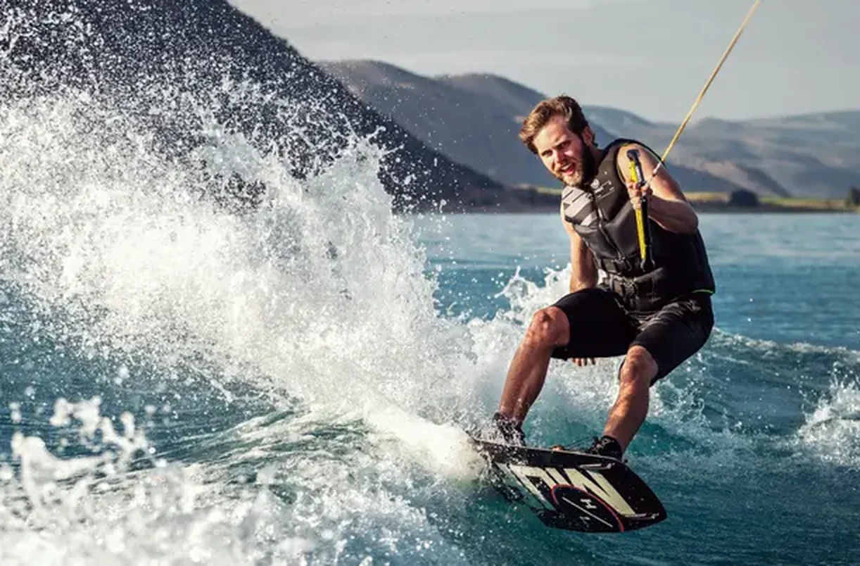 Wakeboarder carving a turn and throwing spray, Camarines Sur