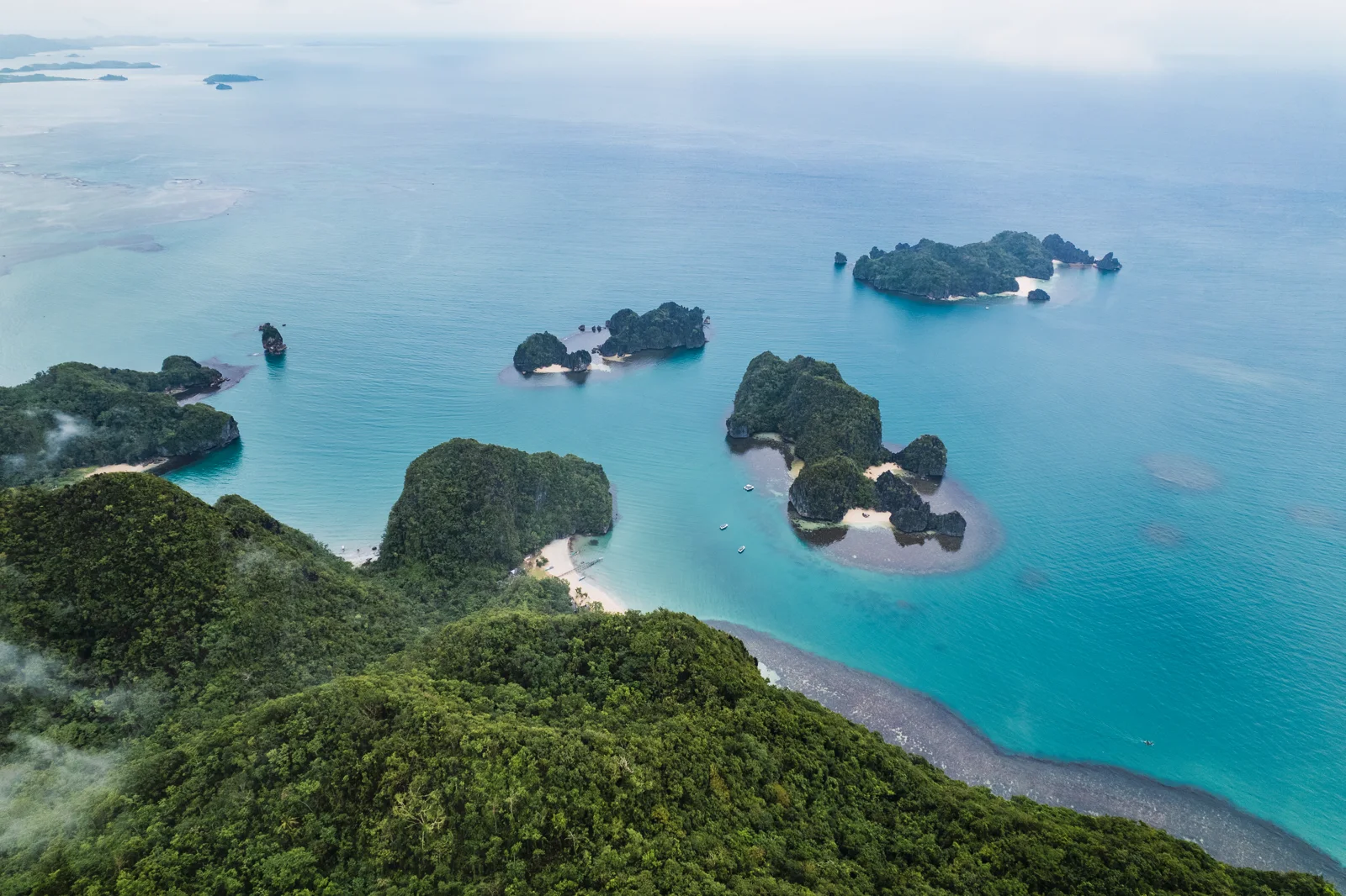 Archipiélago filipino con lanchas tradicionales desde el aire, cerca de El Nido