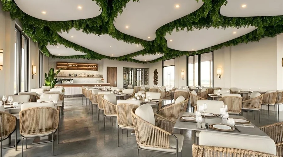 Complex restaurant with its sculpted ceiling, hanging greenery and tables set